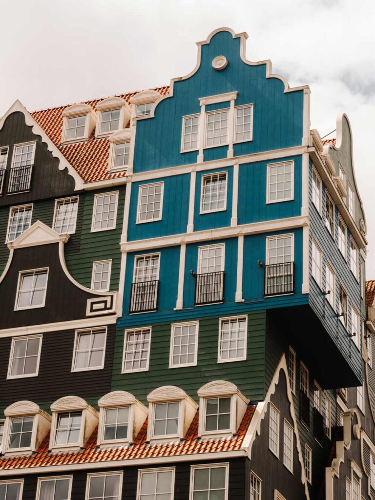A close up photo of the Inntel Hotel in Zaandam. This hotel is known for its exterior which looks like green and blue lego blocks built on top of each other.