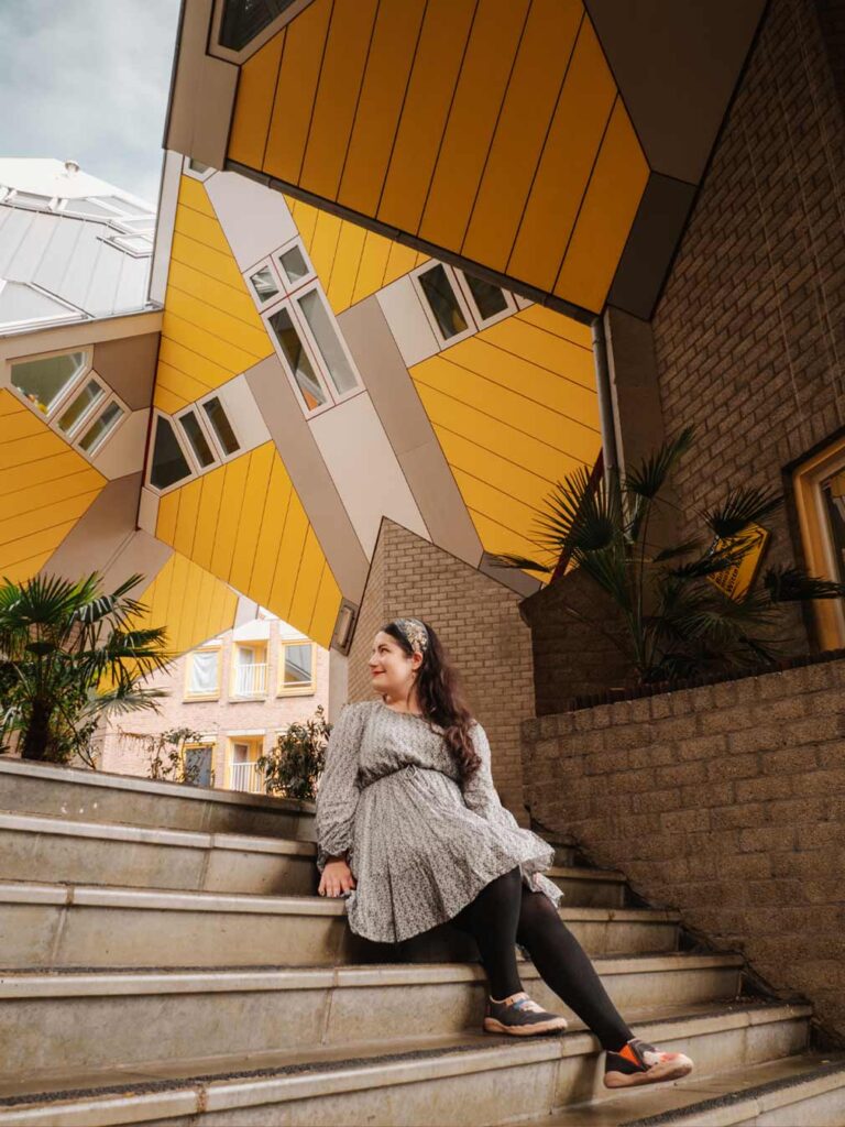 woman-admiring-the-cube-houses-in-rotterdam-netherlands
