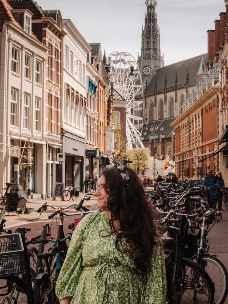 Lauren (the owner of this blog) with views of The Church of Saint Bavo in Haarlem in the background. The church has a towering spire and stands tall above the city. It can often be seen from elsewhere.