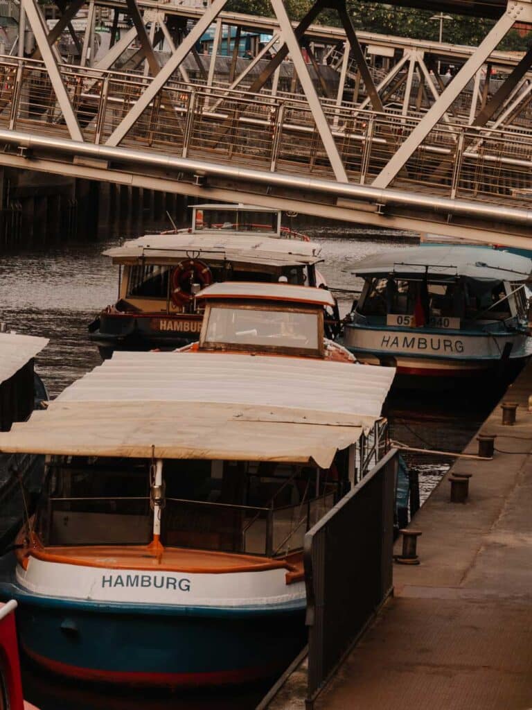 Tourist boats docked in Hamburg ready to take travellers on a cruise through the city.