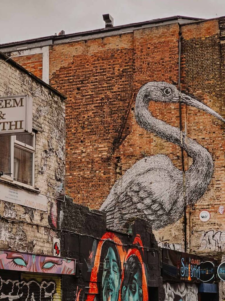Flamingo street art displayed on a brick wall in Brick Lane.
