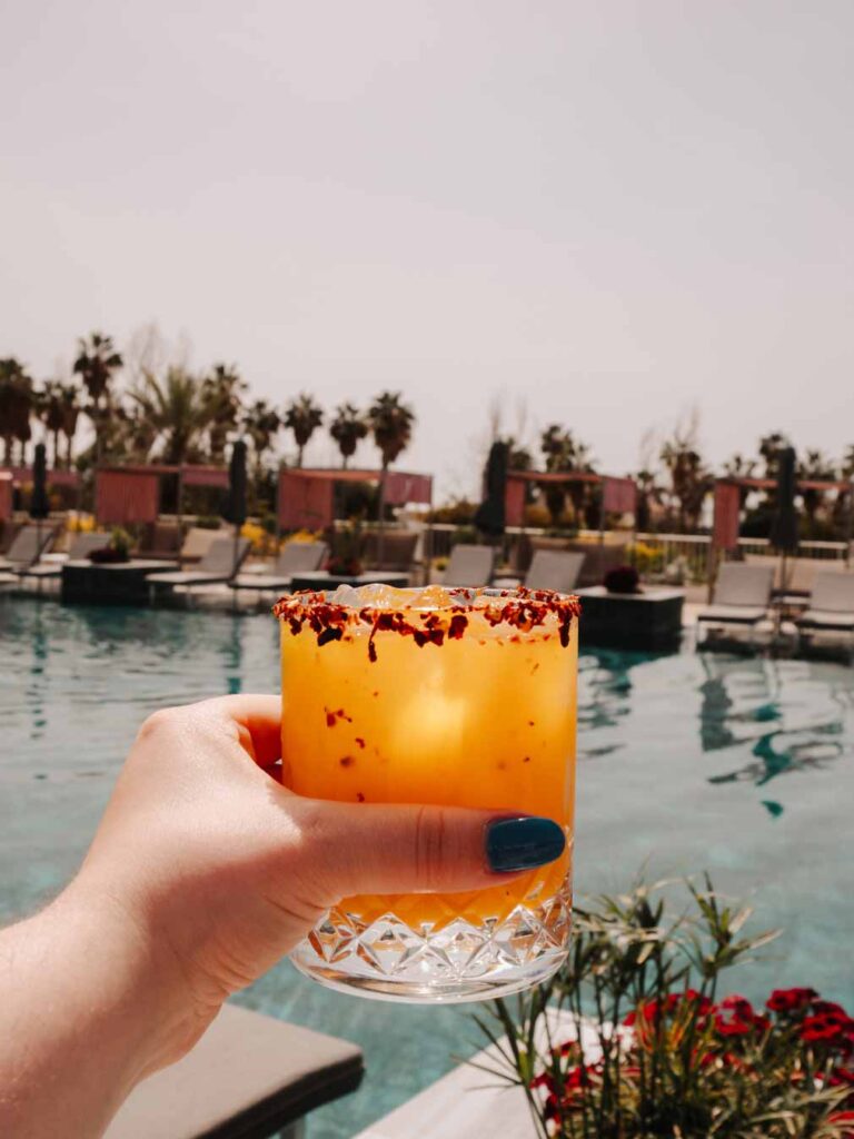 Lauren holding her spicy mangorita cocktail at Calista Pool Bar.
