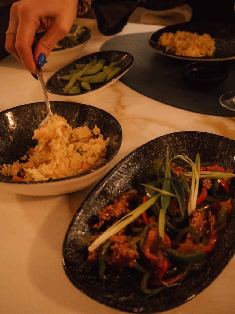 Rice, Korean chicken and other foods on the table at Fiki Japanese Fusion Restaurant.